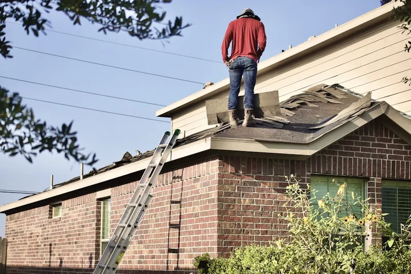 Professional roofer working on a residential roof in Caroline Village